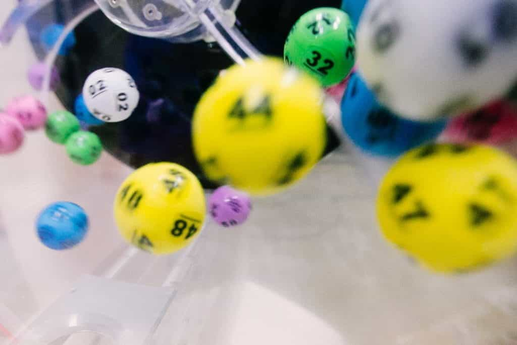 Colorful lottery balls spin in a wheel.