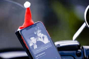 A mobile phone showing Wham’s Last Christmas on its screen.