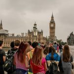 An image showing tourists looking towards the UK's House of Commons.